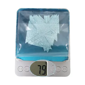 Nahaufnahme von 7,9g hellblauen Glitzer-Schleifen auf einer Digitalwaage für DIY