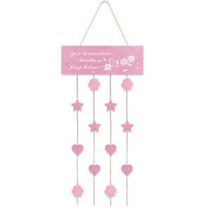 Detail of pink wooden hanging sign with floral pattern, heart and star pendants on ropes