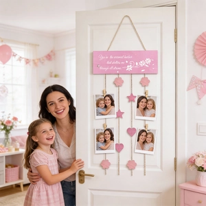 Detail of pink wooden photo display board with heart and star ornaments for Mother's Day