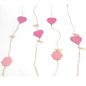 Detail of pink wooden heart and flower clips with jute strings for Mother's Day photo display