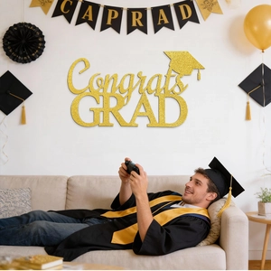 Close-up of gold glitter Congrats GRAD lettering wall decor for graduation party backdrop
