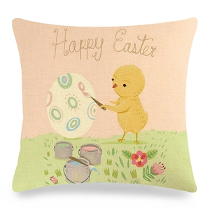 Detail of linen Easter pillowcase featuring a cartoon chick painting eggs and Happy Easter text