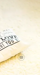 Detail of square pillowcase with 'LOVE WHAT YOU DO' text on thick linen fabric