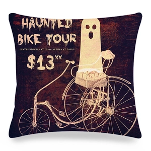 Detail of Halloween pumpkin linen pillowcase featuring a vintage ghost on a bicycle design