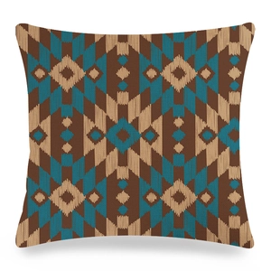 Close-up of square linen cushion cover with geometric patterns in brown and blue
