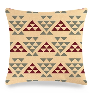 Detailed view of linen cushion cover with burgundy and grey geometric triangle patterns