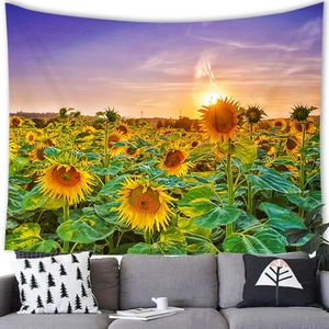 Detail view of sunflower landscape tapestry hanging over a modern grey sofa