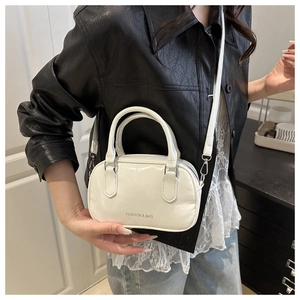 Detail view of white vintage oil wax leather boston bag with silver hardware and logo