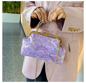 Close-up of purple sequin handbag showing wavy patterns and golden ball clasp
