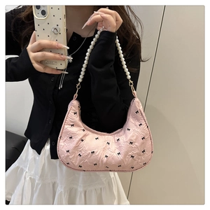 Sac hobo rose avec motifs de nœuds noirs et bandoulière élégante en perles
