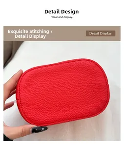 Gros plan des coutures précises et du cuir grainé rouge sur le sac à main