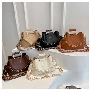 Detailed view of fashion bucket bags in five colors with metal handles and chain straps