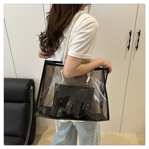 Close-up of transparent PVC tote bag with rope handles and a black inner pouch