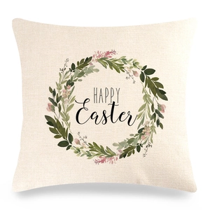 Detail of square linen pillowcase with watercolor floral wreath and Happy Easter text