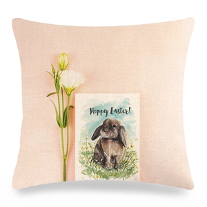 Detail view of linen Easter pillow cover with watercolor bunny and Hoppy Easter text
