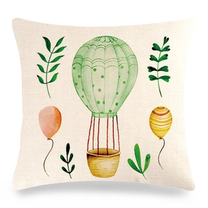 Detail of linen pillowcase featuring watercolor hot air balloon and green foliage textures