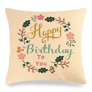 Detailed macro view of beige linen cushion cover with Happy Birthday floral wreath print