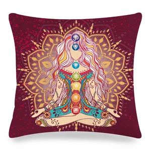 Close-up of linen mandala pillow cover with meditating figure and seven chakra symbols