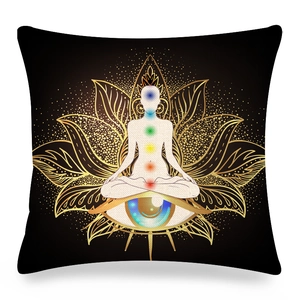 Detailed macro view of the gold lotus flower and chakra meditation figure on a linen cushion