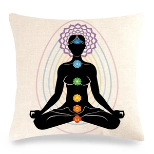 Close-up of linen yoga pillow cover showing seven chakra symbols and mandala patterns