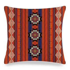 Linen cushion cover with orange and blue geometric Navajo tribal patterns on white background