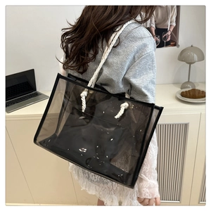 Detailed shot of transparent black PVC tote with hemp rope handles and inner pouch