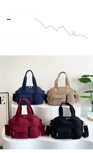 Group display of high-capacity nylon pillow bags in navy, beige, wine red, and black colors