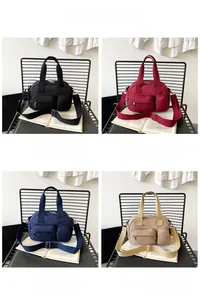Detailed view of nylon pillow bags in black, red, blue, and khaki with multi-zipper design