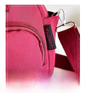 Detail of red nylon bag with speedMai brand label, smooth zipper and silver metal hook
