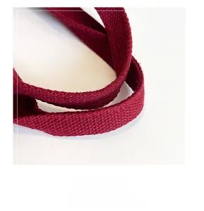 Close-up of durable dark red canvas woven handle with premium twill texture detail