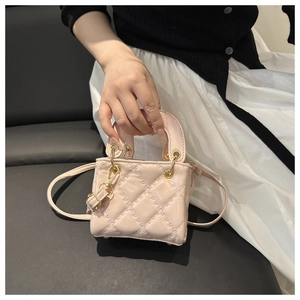 Detailed shot of pink quilted patent leather micro bag with gold metal hardware