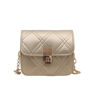 Elegant gold quilted chain crossbody bag with metallic finish and rotary lock