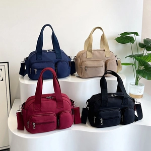 Minimalist nylon Boston bag with multiple pockets and adjustable strap in four colors