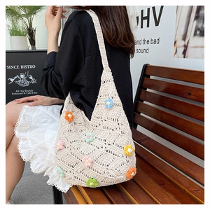 Detail of floral crochet shoulder bag with colorful 3D flowers for summer beach