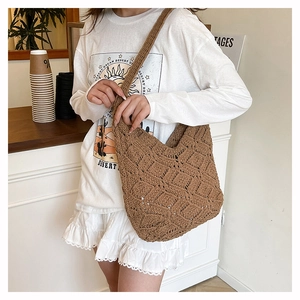Detailed macro view of the brown crochet shoulder bag featuring retro hollow flower knit texture