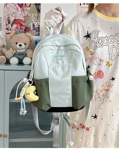 Detail of color-block backpack with drawstring side pocket and plush moon charm