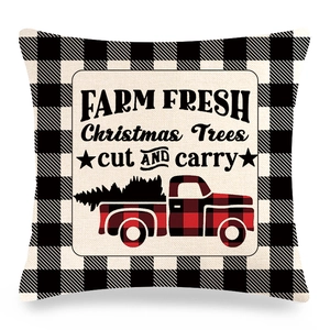 Detail of linen Christmas pillow case with buffalo plaid and red farmhouse truck