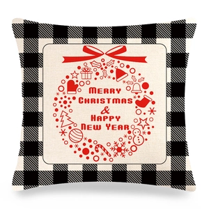 Detail of Christmas buffalo plaid linen pillowcase with festive wreath and holiday greeting