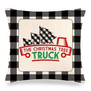 Close-up of linen pillowcase with black buffalo plaid border and red Christmas truck design