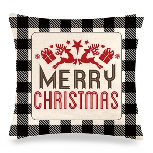Macro view of Christmas pillow cover with black plaid borders and Merry Christmas print