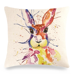 Detail of linen pillowcase showing colorful watercolor rabbit print and woven fabric texture