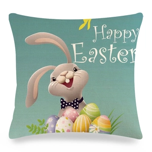 Detail of linen Easter cushion cover with bunny and colorful eggs on mint background
