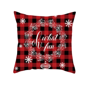 Red and black buffalo plaid Christmas pillow cover with white floral wreath and oh what fun text