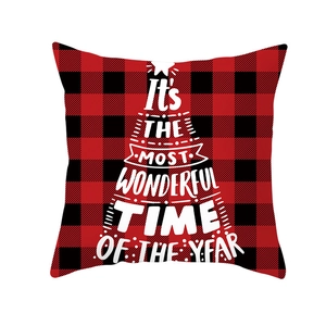 Close-up of red and black buffalo plaid Christmas pillow cover with white tree typography