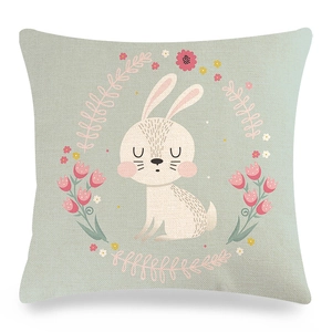 Detail of linen pillowcase with white bunny and pink tulip wreath on teal background