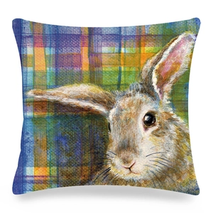 Detail of artistic Easter rabbit print on textured linen pillow cover with plaid background