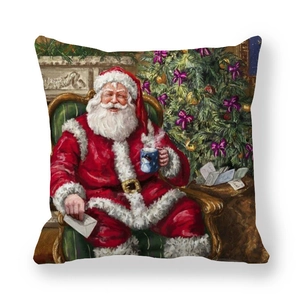 Detail of Christmas pillow cover showing Santa Claus sitting near a decorated holiday tree