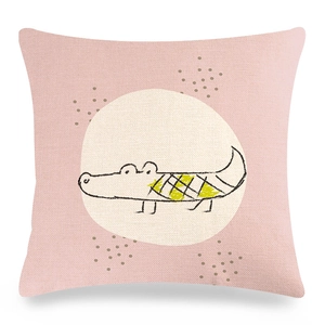 Detail showing knit texture of linen pillow case with cute cartoon crocodile print