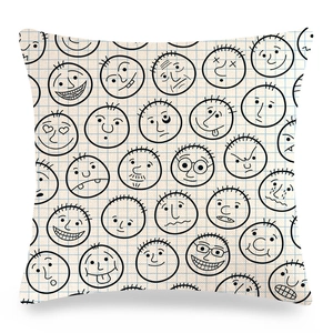 Detailed view of square linen pillow cover with cartoon face doodles and blue plaid patterns