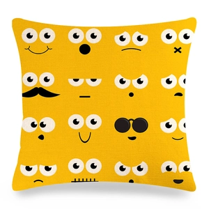 Close-up of yellow linen pillowcase with 16 black emoji expressions and fiber texture